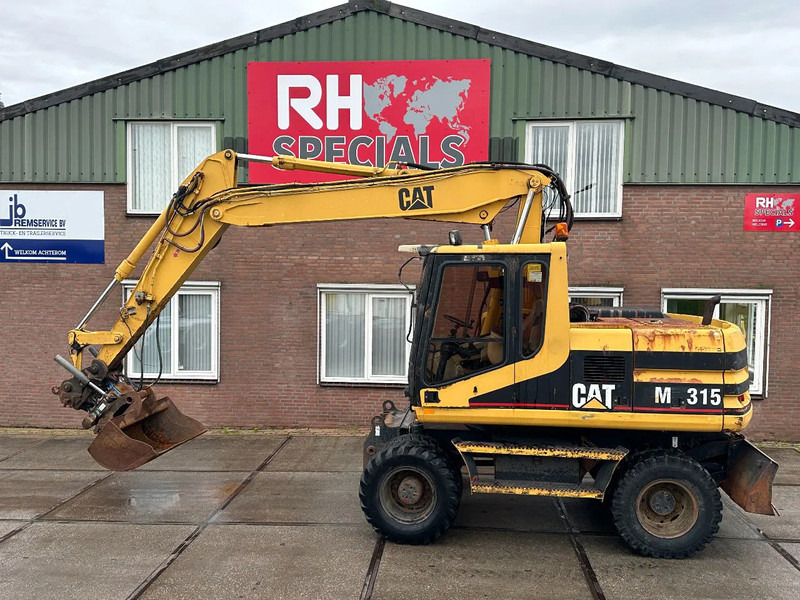 Caterpillar M315 +ROTO CE - Wheel excavator: picture 1 Caterpillar M315 +ROTO CE - Wheel excavator: picture 1